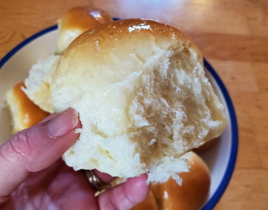 Image shows a bowl filled with Buttery Dinner Rolls.