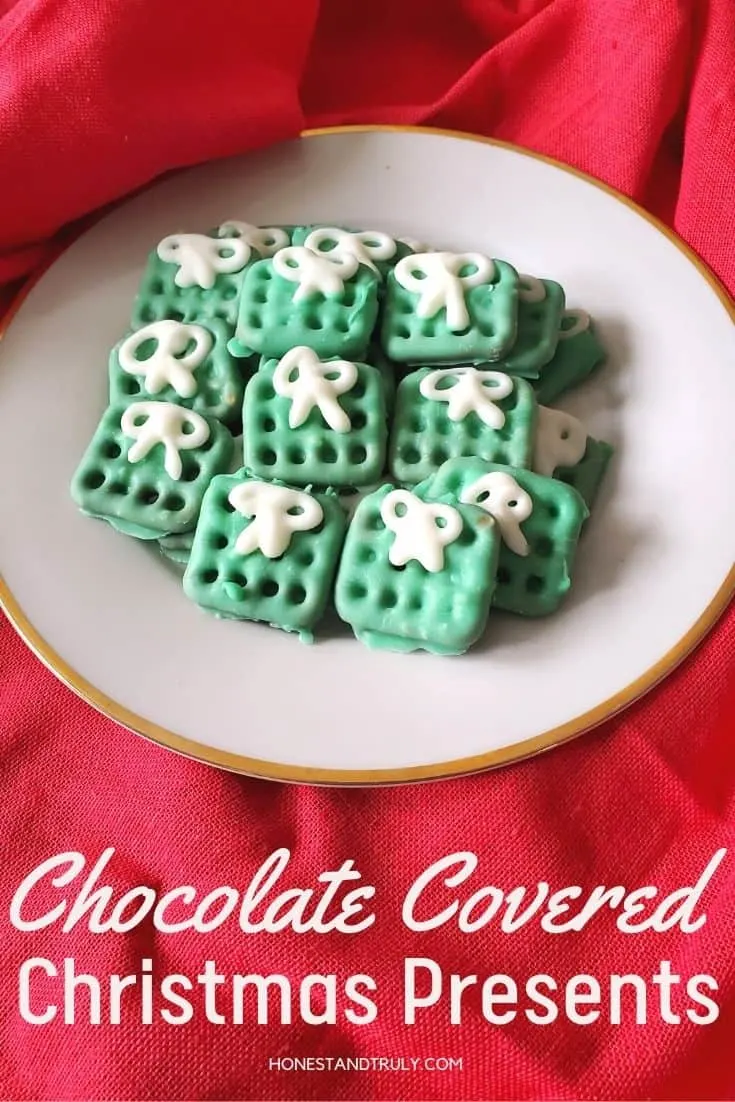 Chocolate covered pretzels on a plate with red background