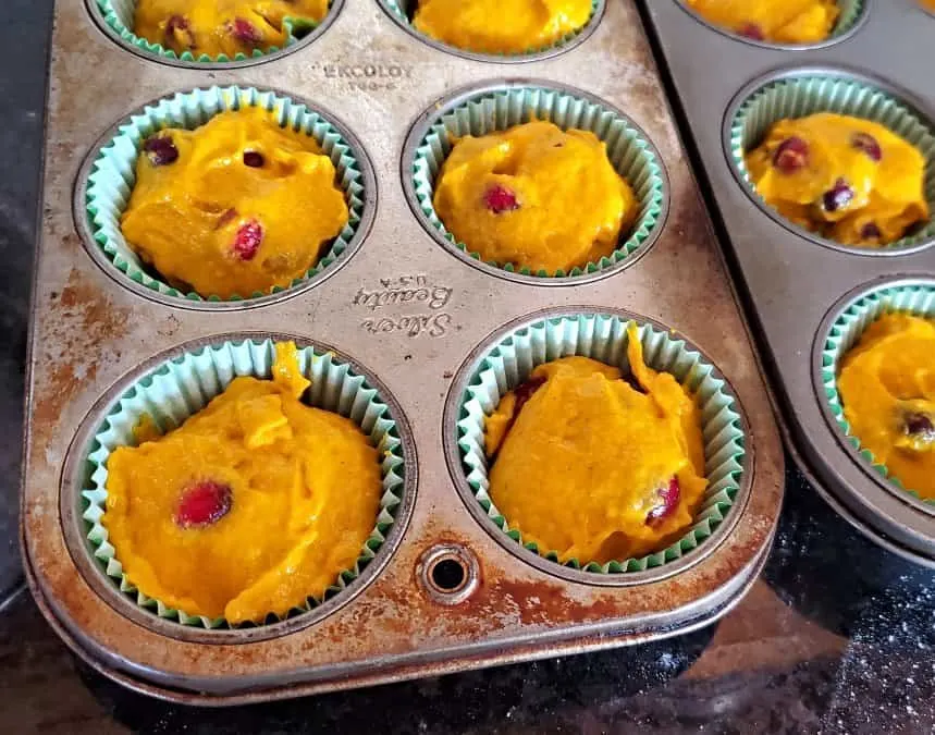 Muffin tins filled nearly to the top with batter