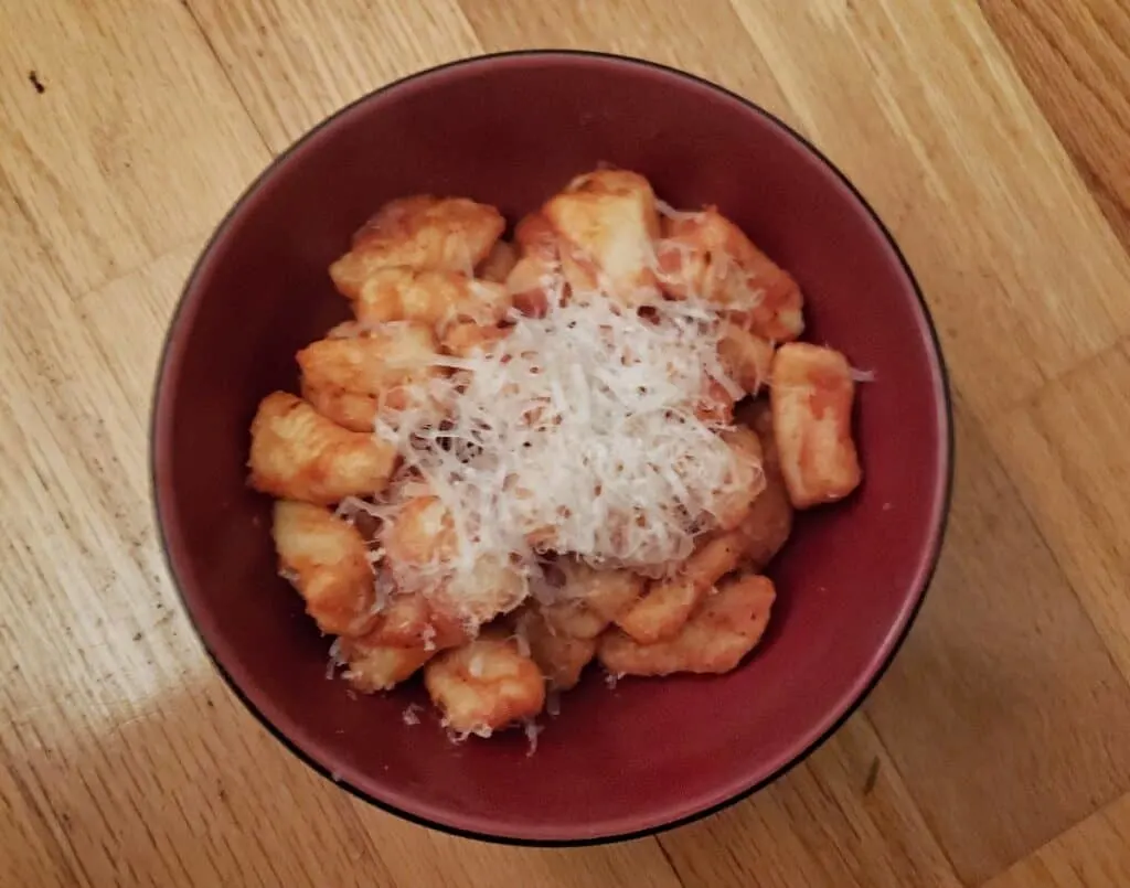 Bowl of homemade gnocchi with parmesan