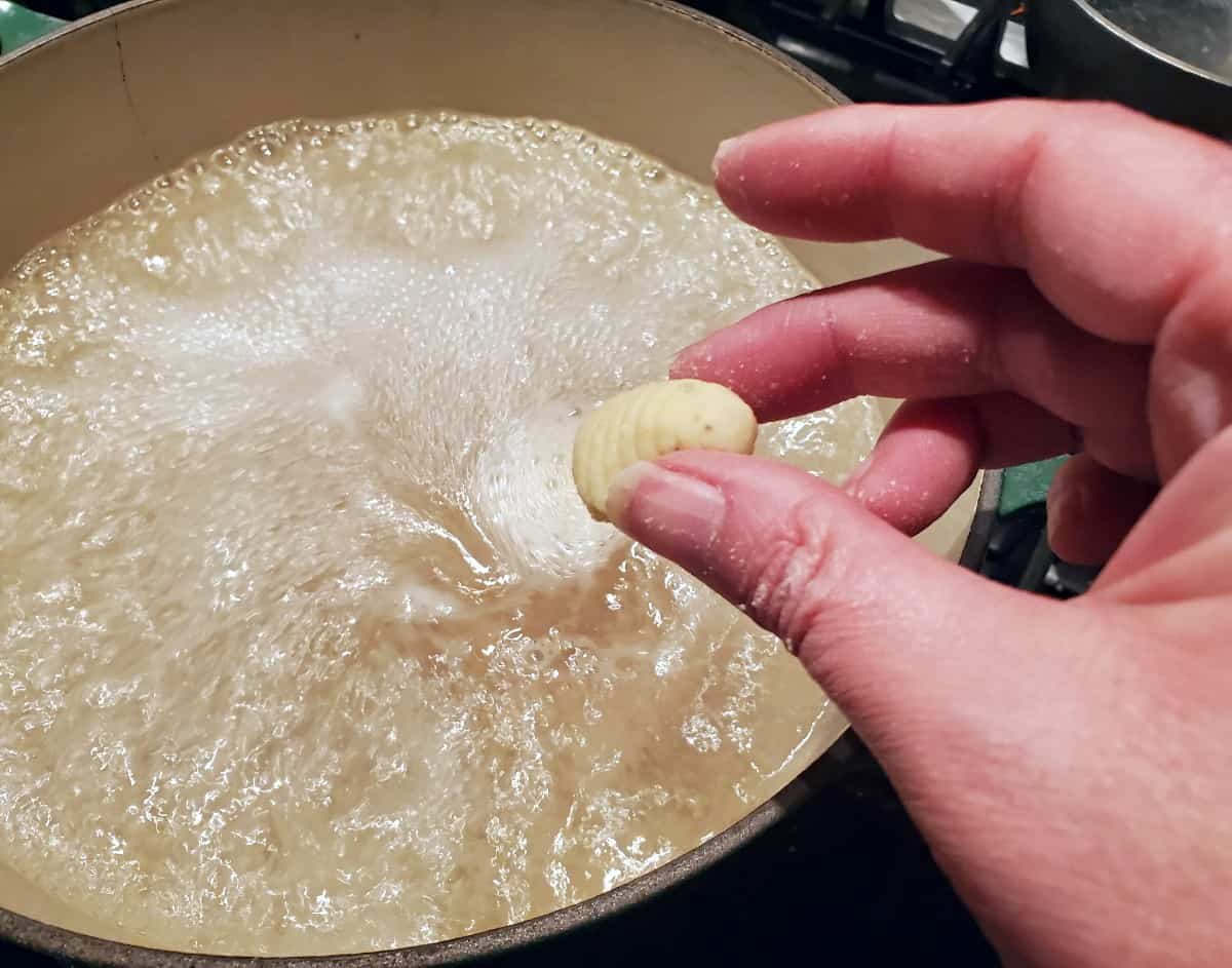Dropping gnocchi into boiling water