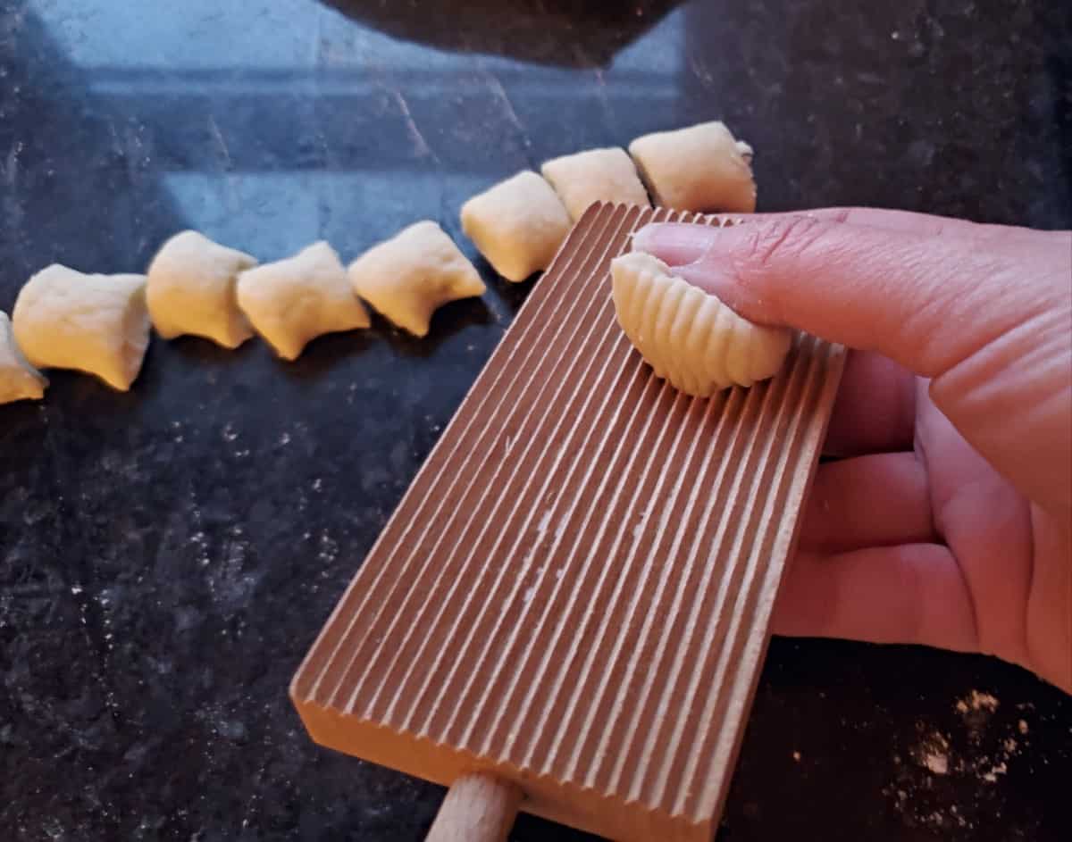 Rolling gnocchi pieces on gnocchi board