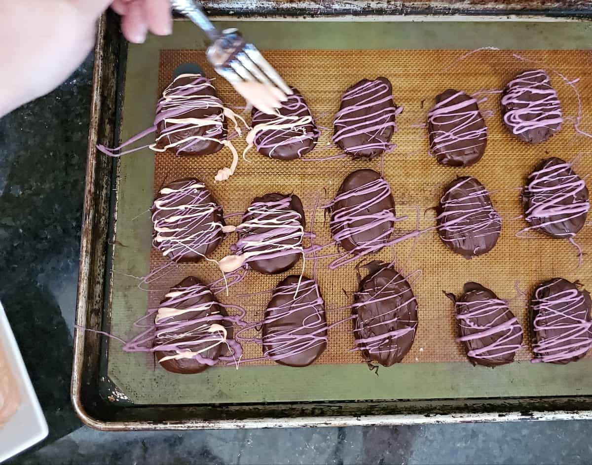 Drizzle chocolate over eggs to decorate.