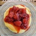 Overhead closeup of pancakes with strawberry syrup