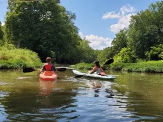 River kayaking with two teenagers.