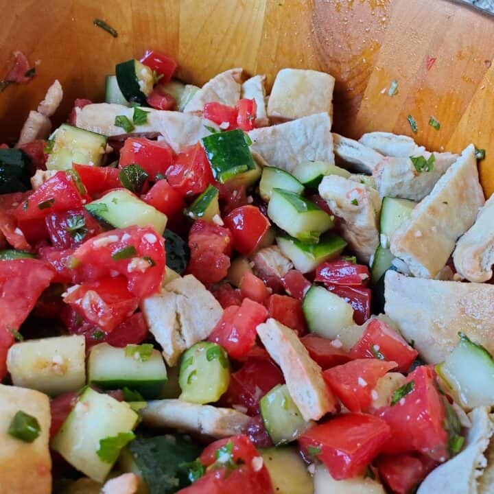 Closeup of a bowl of Mediterranean cucumber tomato salad.