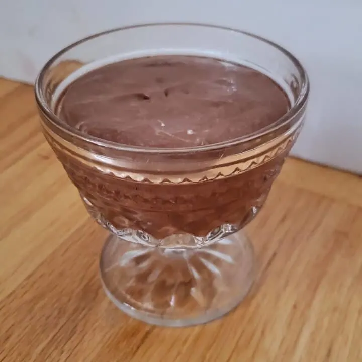 Closeup of bourbon chocolate mousse in a textured glass.