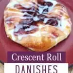 Danish on a red plate with text crescent roll danishes from scratch.
