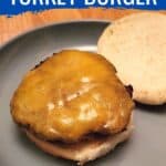 Cheeseburger on a blue plate with top bun behind it with text Flavorful moist turkey burger.