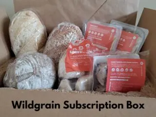 Carb subscription box items propped up in a cardboard shipping box.