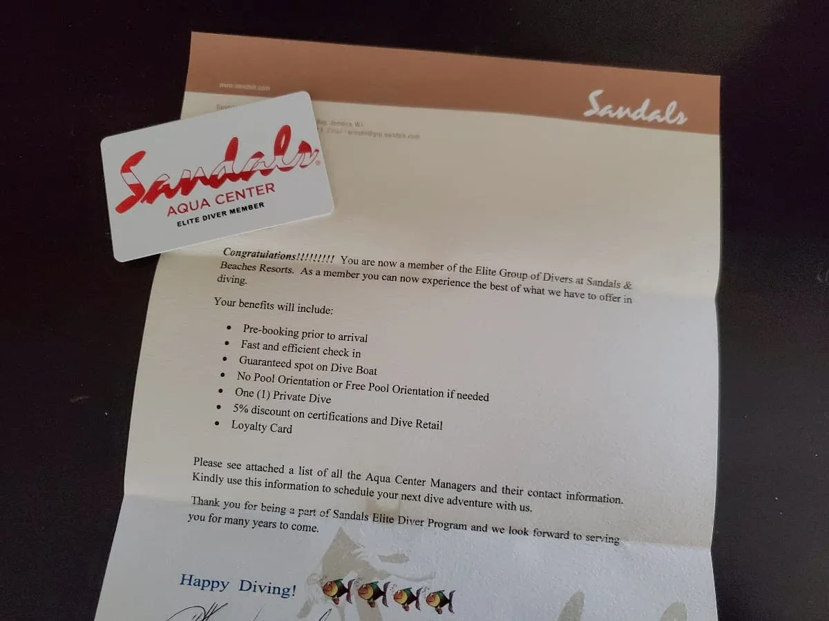 Sandals Elite Diver welcome letter with card sitting near the top left.