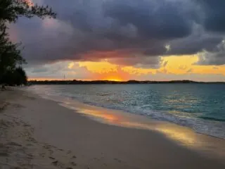 Sunset with clouds on a beach.