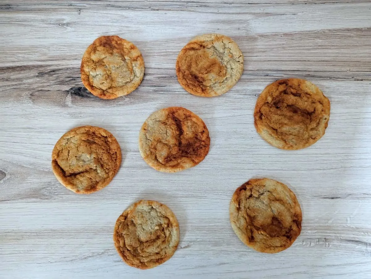 Image shows a wooden table with gochujang caramel cookies on it.