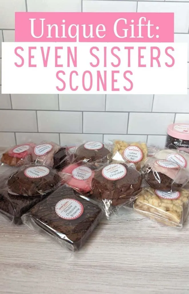 Baked goods displayed on a wooden board with text unique gift Seven Sisters Scones.