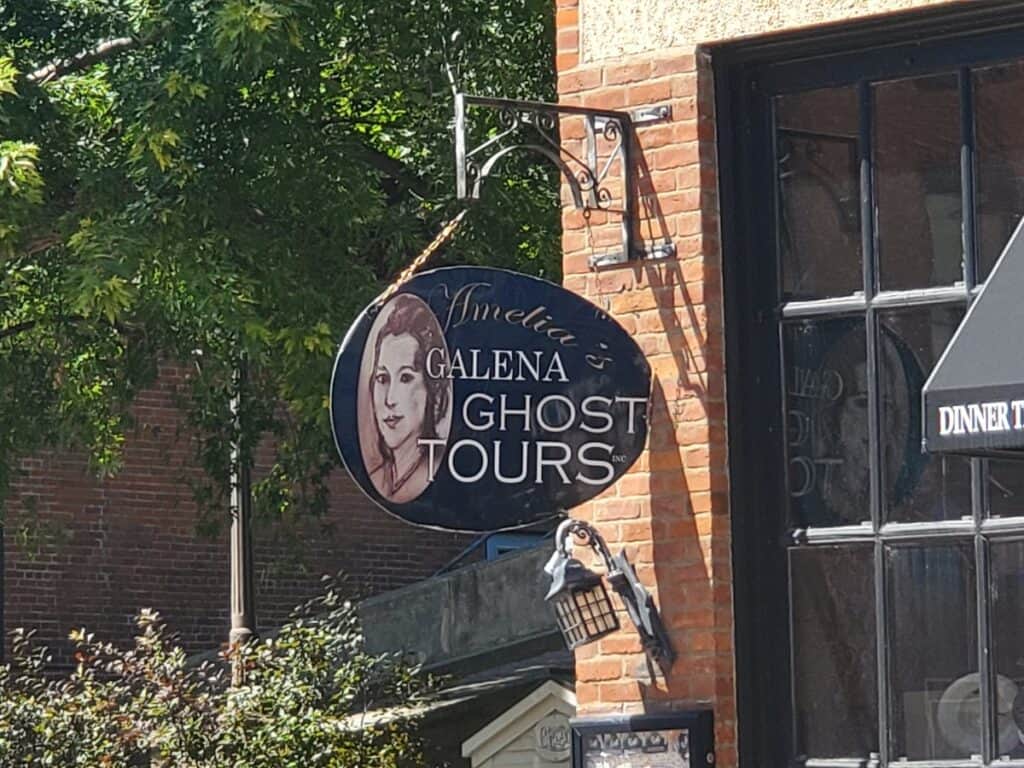 Exterior hanging sign advertising Amelias Galena Ghost Tours.