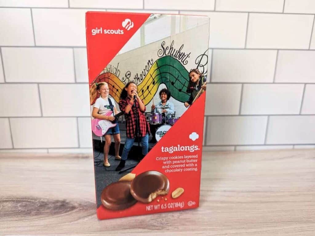 Image shows Girl Scouts Cookie Tagalongs Peanut Butter Patties flavor on a wooden counter.