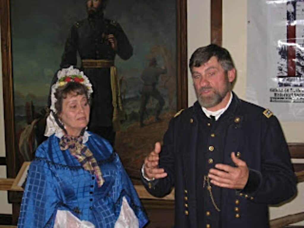 US Grant and his wife reenactors lecturing in front of a painting in Galena Illinois.
