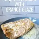 Orange salmon on a blue plate with text easy no fuss poached salmon with orange glaze.