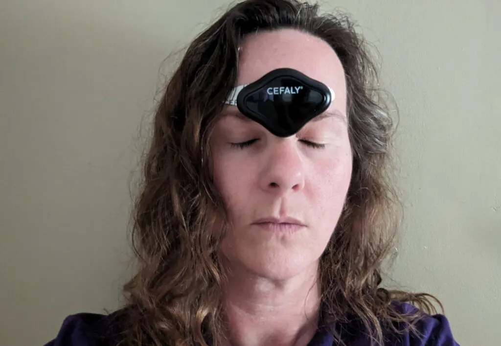 Image shows a Woman with CEFALY device on her forehead.