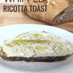 Image shows Whipped ricotta toast with bread in the background with text easy whipped ricotta toast.