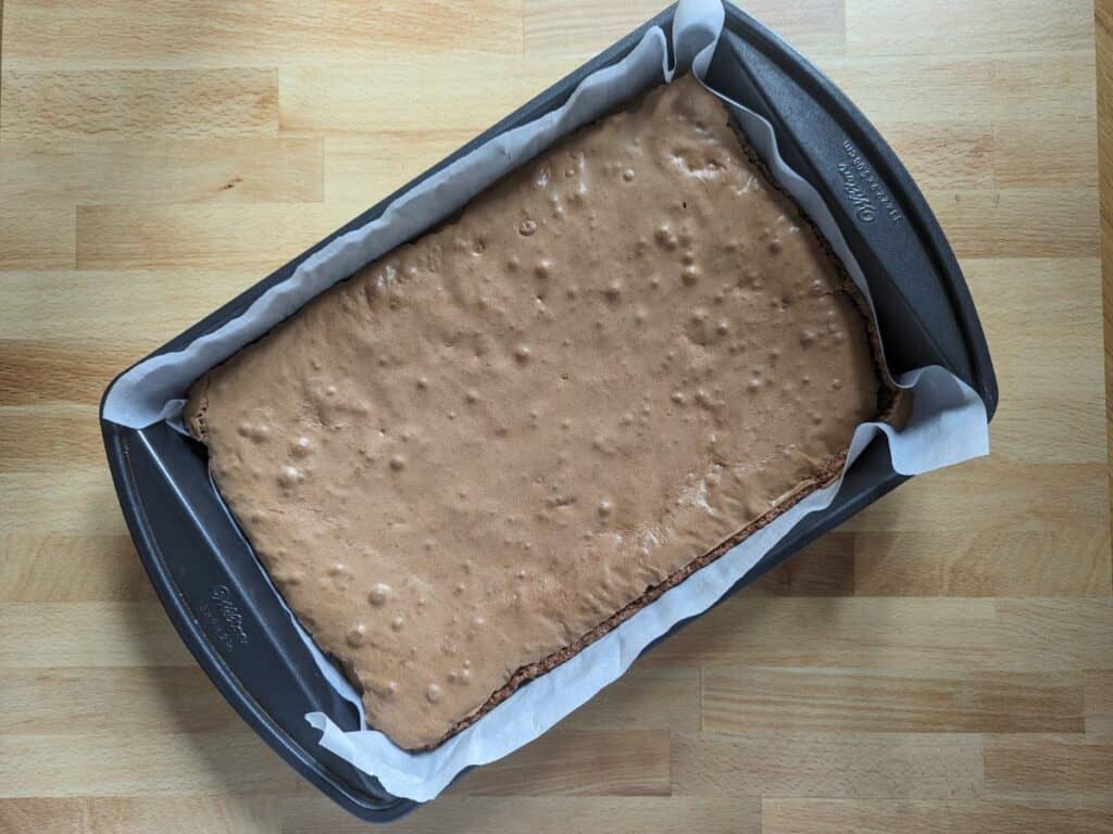 Image shows Overhead of brownies baked in a pan.