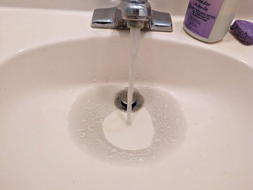 Image shows Water running black after changing a water filter.