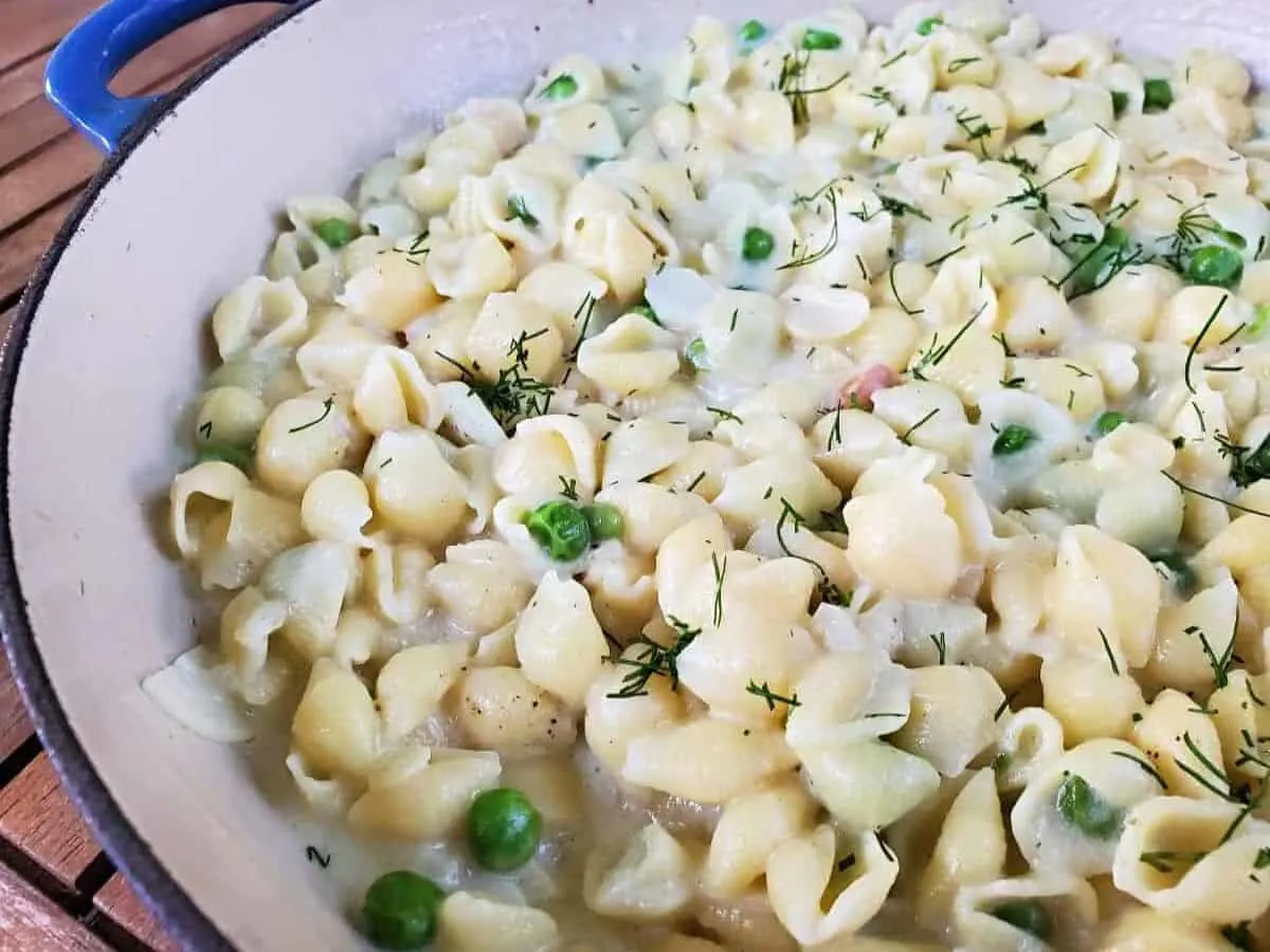 Image shows Creamy Pea Pasta in an enameled cast iron pot.