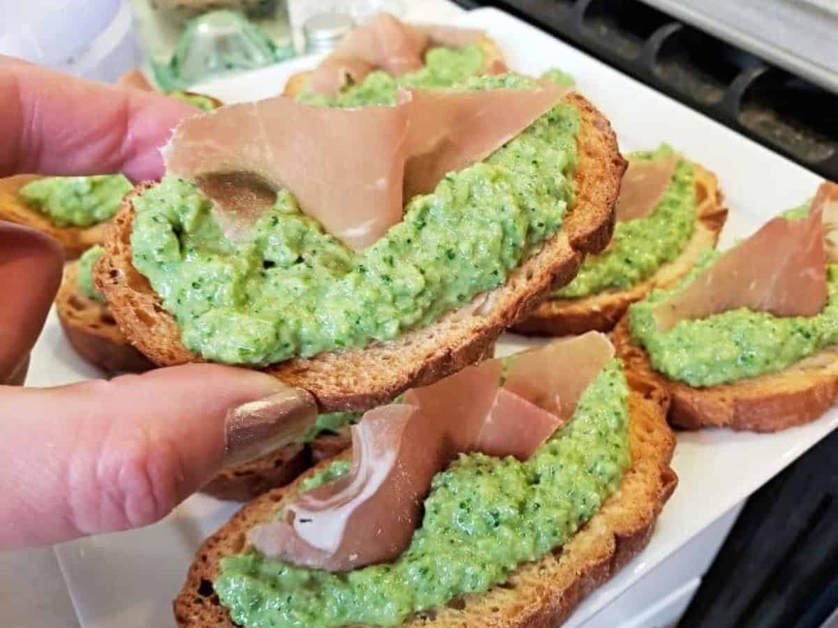 Image shows a white tray with Whipped Vegetable Bruschetta close up.