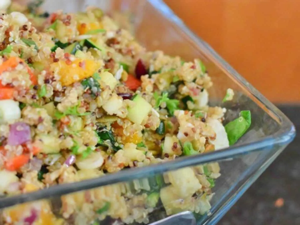 Image shows a closeup head on shot of Harvest Quinoa Salad in a glass bowl.