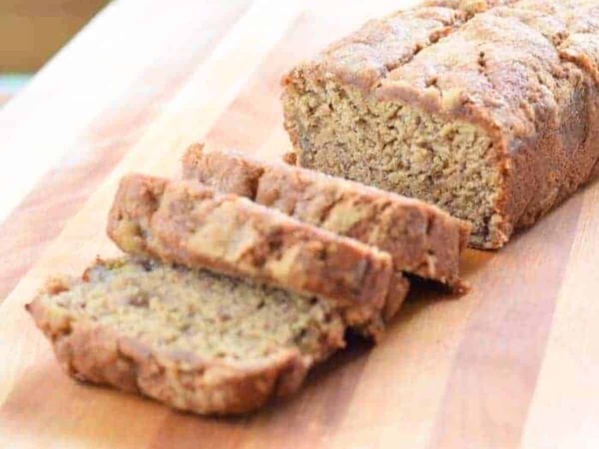 Slices of banana bread stacked on a cutting board.