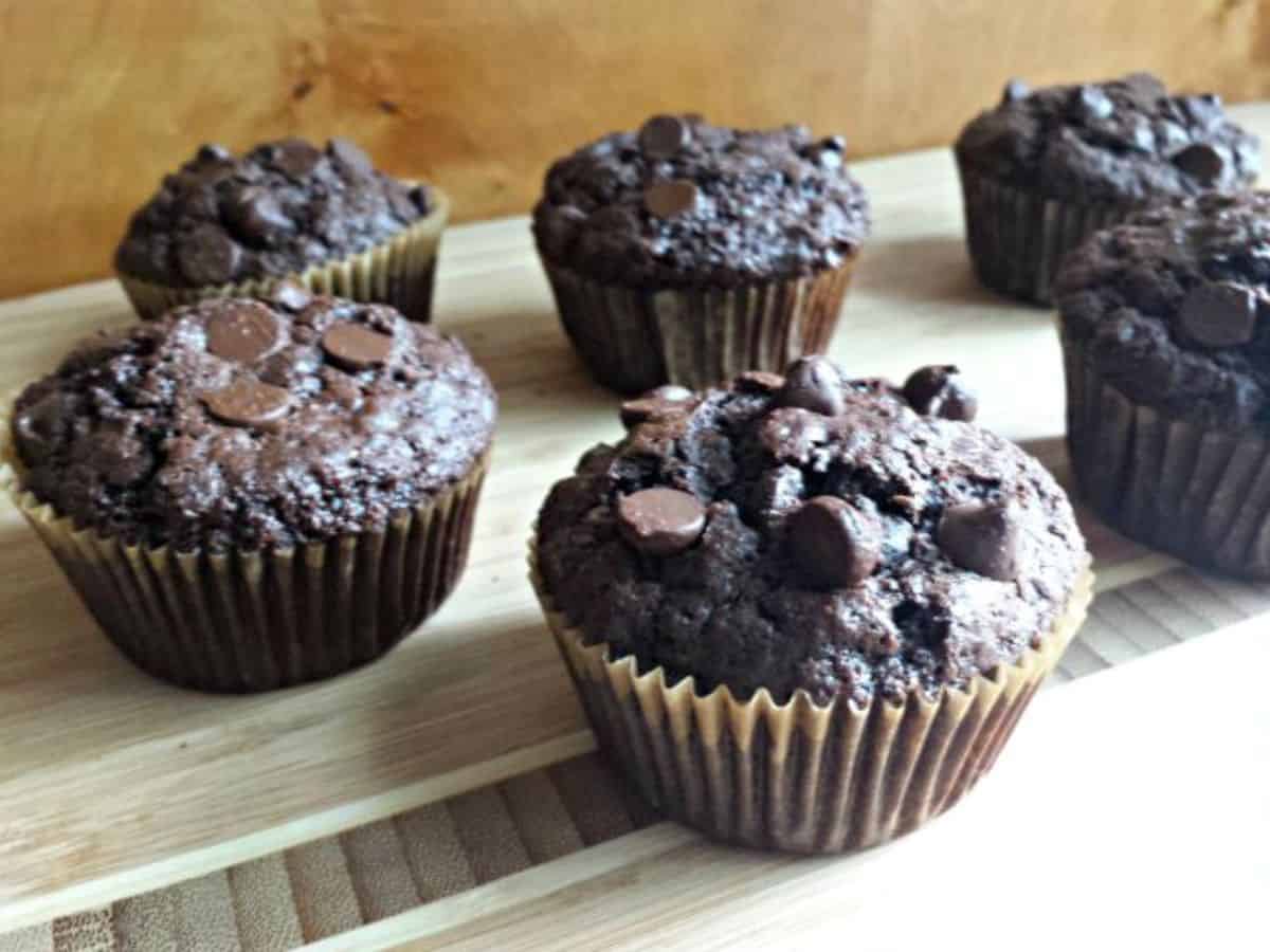 Dairy free chocolate chip muffins on a wooden cutting board.