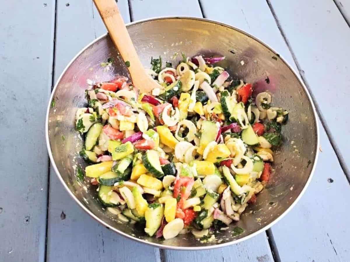 Silver bowl with a veggie filled hearts of palm salad.