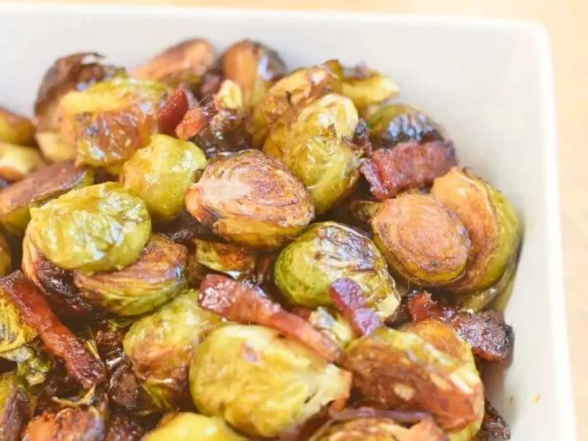 Roasted brussels sprouts with caramelized edges in a serving dish.