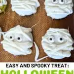 Image shows a Closeup of mummy oreos with text easy and spooky treat: Halloween mummy oreos.