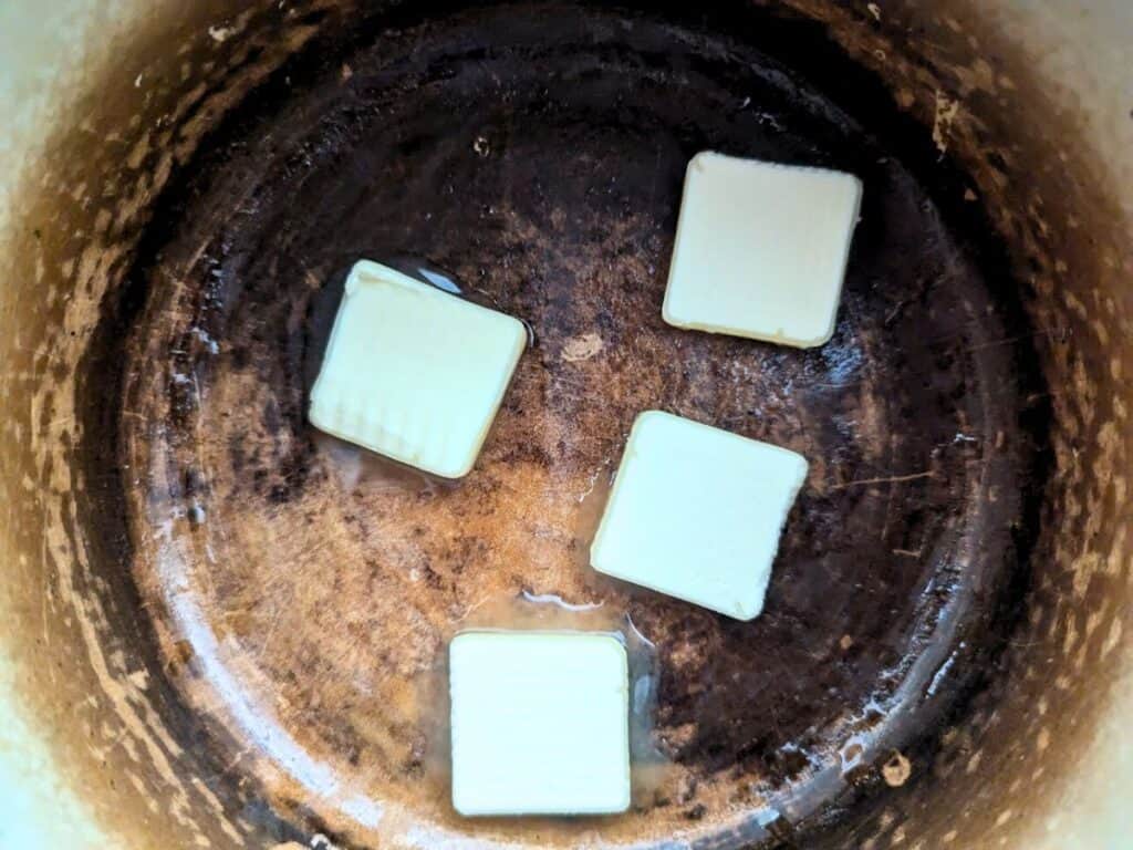 Image shows melting butter in a pot.