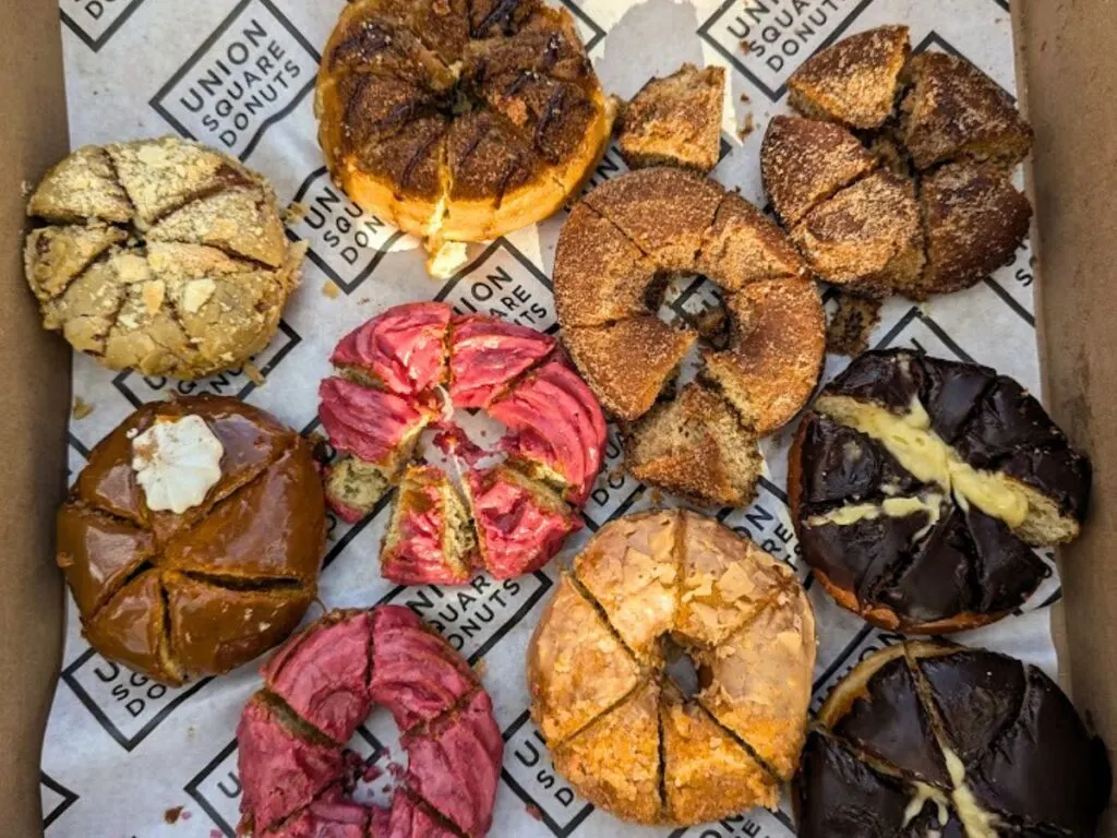 Image shows Union Square Donuts each cut into pieces for sampling.